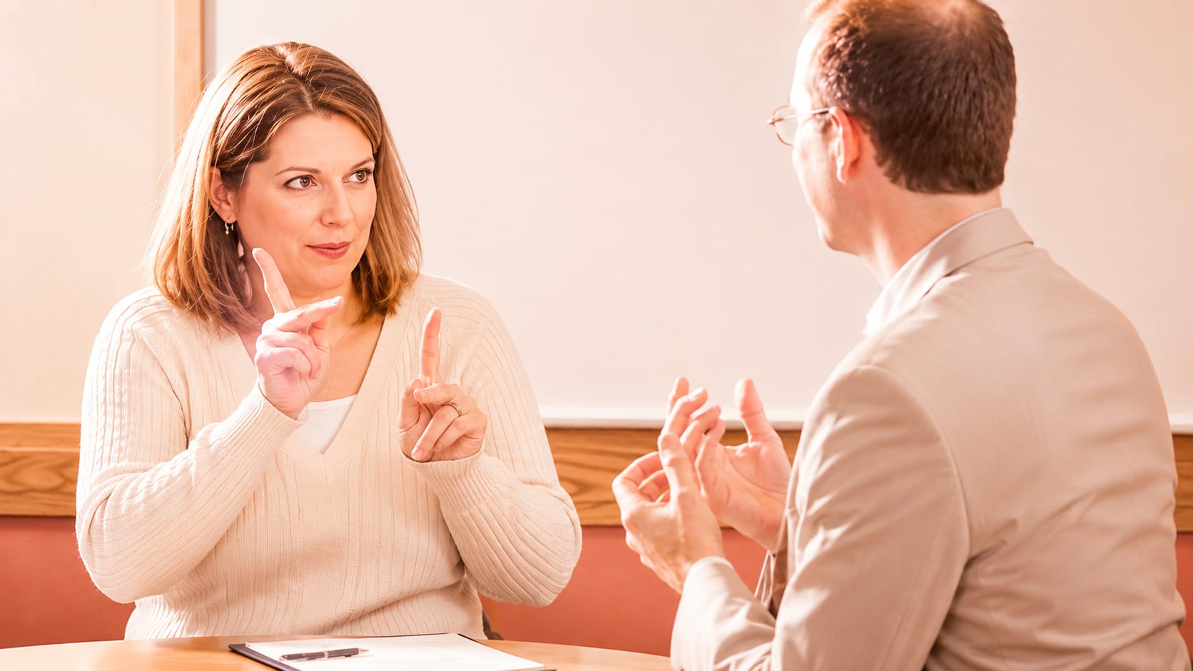 An interpreter mid-lesson, the service in motion.